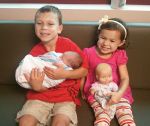 Big brother Baine and big sister Aida Lynn with their little brother Alexander Mathis Thompson.